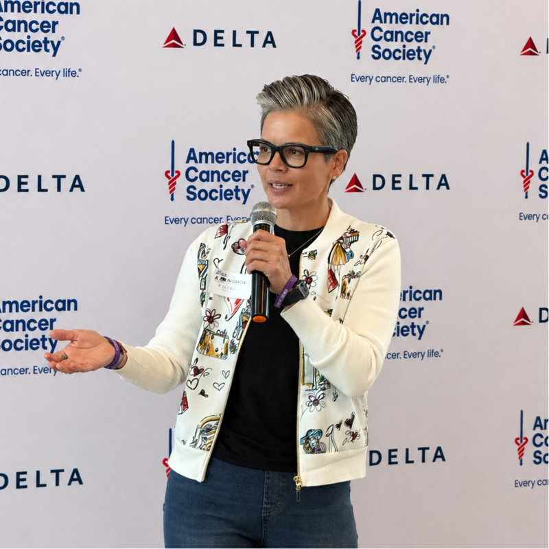 Amanda DevLugt holding up a quarter, presenting The Power of a Quarter keynote at SHIFT 2026.